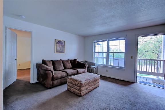Image of carpeted room with furniture and window