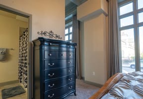 a bedroom with a dresser and a window
