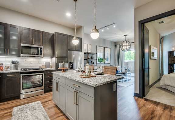 A modern kitchen with wooden cabinets and stainless steel appliances.