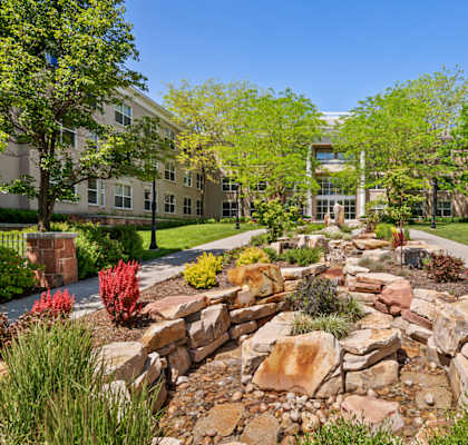 a large rock garden in front of an apartment building