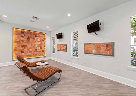 A room with a chair and a painting on the wall.at Elan Apartments, Fort Walton Beach, FL