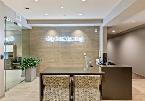 a large desk in the lobby of city creek landing