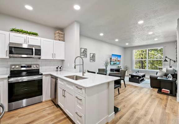 a kitchen and living room with a large window
