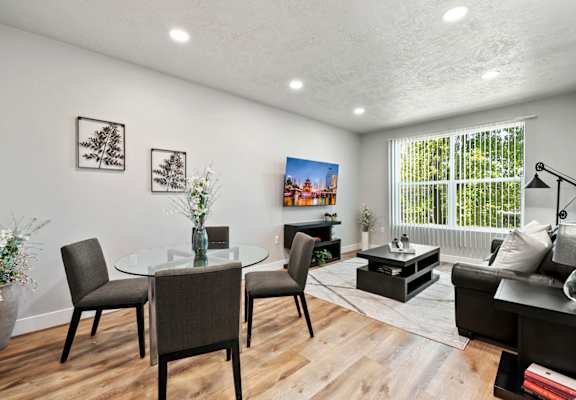 a living room with white walls and a large window