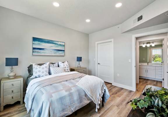 a bedroom with a bed and two night stands