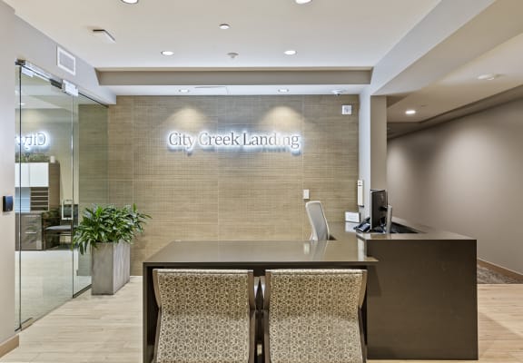 a large desk in the lobby of city creek landing