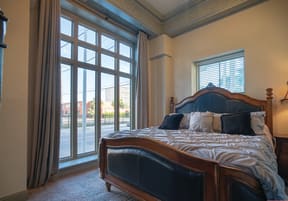 a bedroom with a large bed and a window