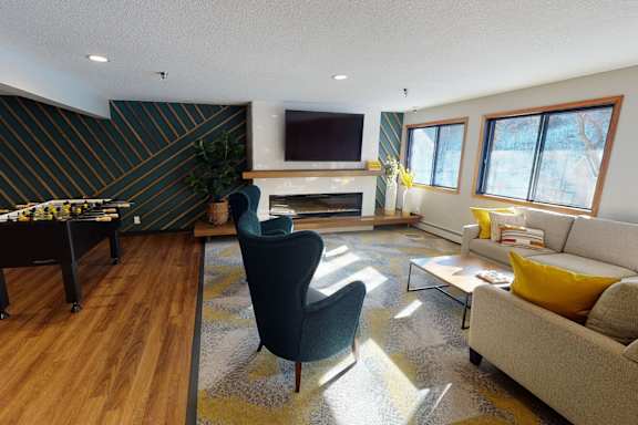 A living room with a fireplace and a television.