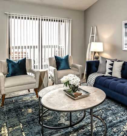 a living room with a blue couch and a coffee table