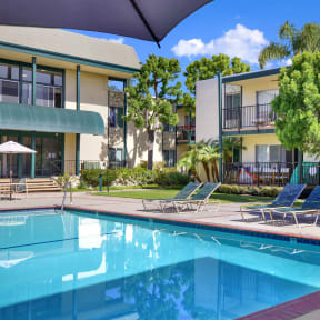 a swimming pool in front of an apartment building at Copa Ladeene Apartments, California