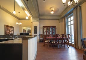 a dining room and kitchen with a table and chairs