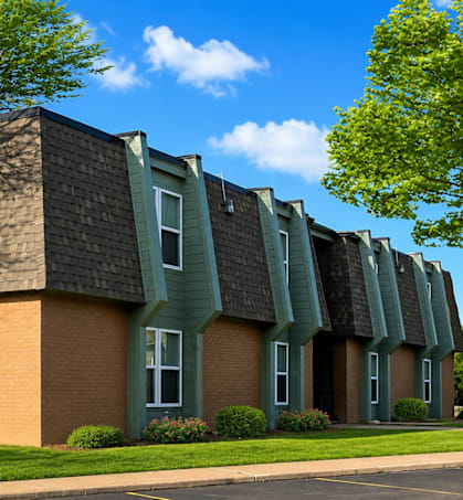A building with a green roof and a brick facade.