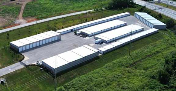 A large industrial building complex with multiple warehouses and a parking lot.