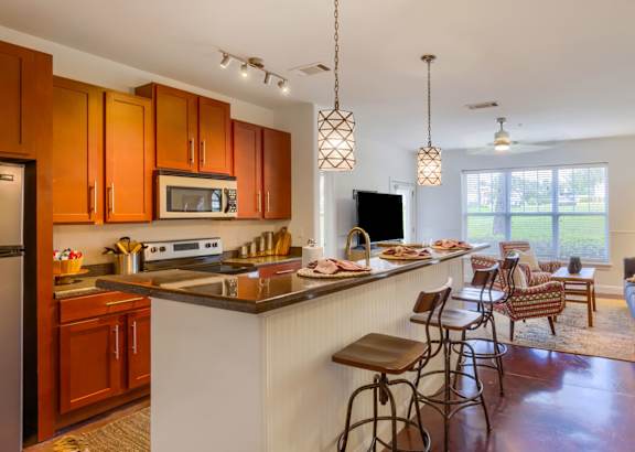 a kitchen with white cabinets and a granite counter top