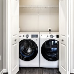 a laundry room with two washes and a dryer