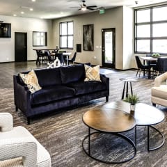 a living room with couches and chairs and a table