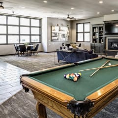 an open living room with a pool table and a tv