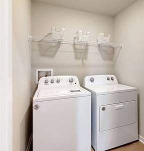 A small laundry room with a washer and dryer.