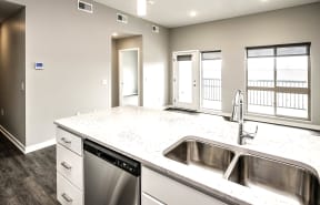 an empty kitchen with a stainless steel sink and counter top