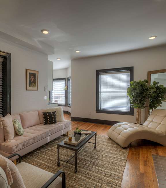 A living room with a couch, chair, and coffee table.