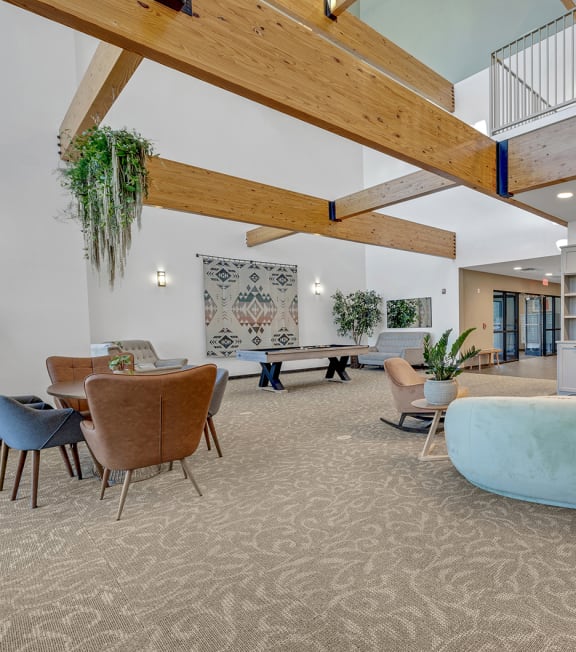 a living room with a couch and a table and chairs