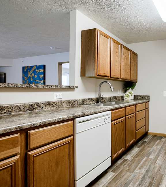 A kitchen with a white oven and microwave above it.