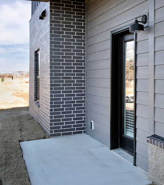 A modern house with a black door and a window.