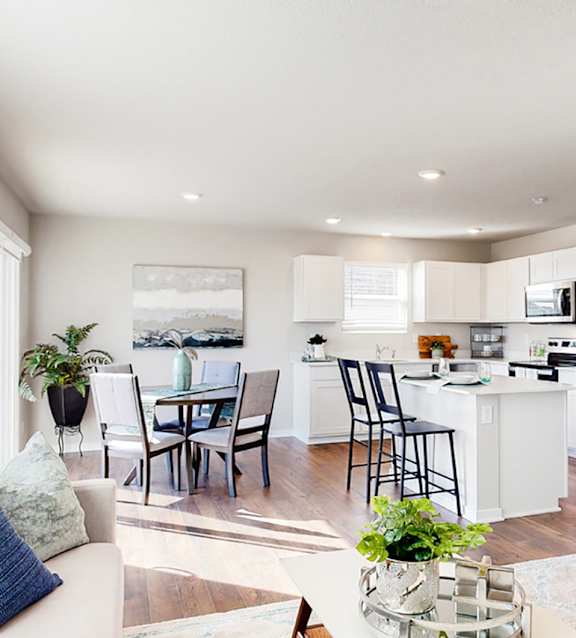 A modern kitchen with a dining table and chairs.