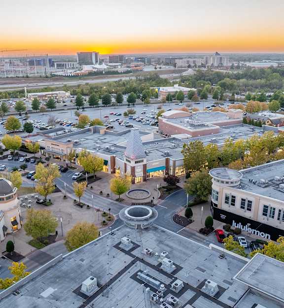 A sunset view of a cityscape with a large open square in the center.