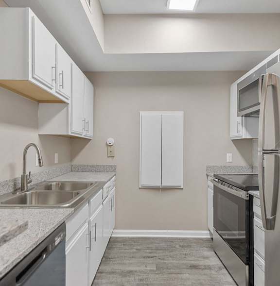 A kitchen with white appliances and cabinets.