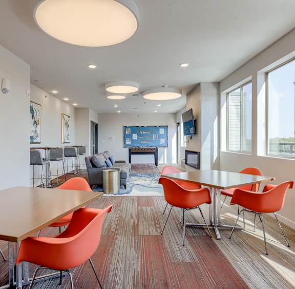 A conference room with a long table and chairs.