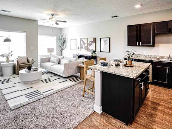 a living room with a kitchen and a couch