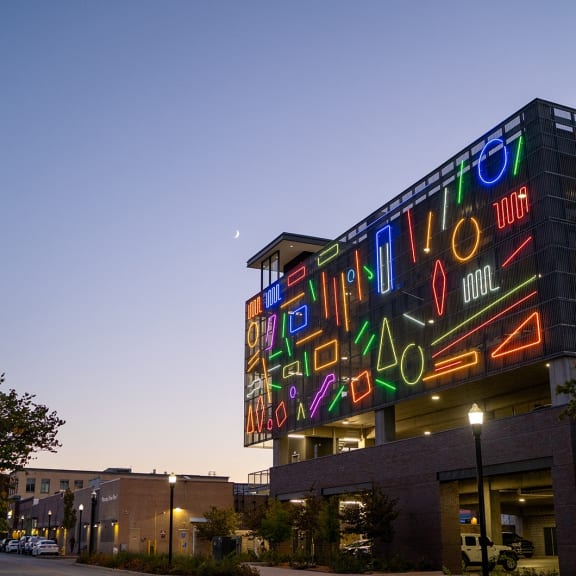 a large neon sign on the side of a building at night