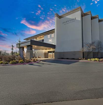 the building where the hotel is located is shown at sunset