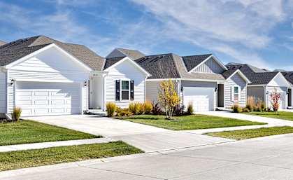 A row of houses with a clear blue sky above them.