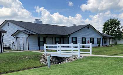 a white building with a white fence in front of it