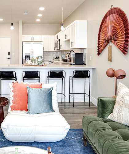 A modern kitchen with white cabinets and a bar area.