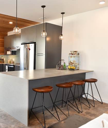 a kitchen with a large island with three stools