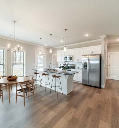 A modern kitchen with a dining table and chairs.