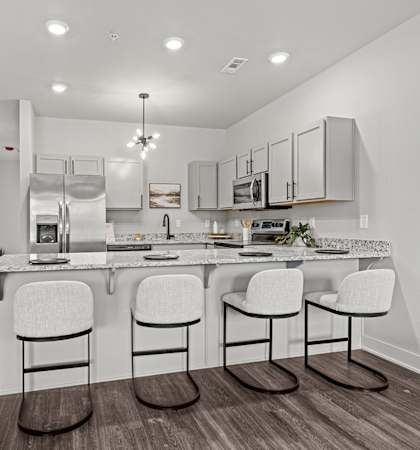 a kitchen with an island with three stools in front of it