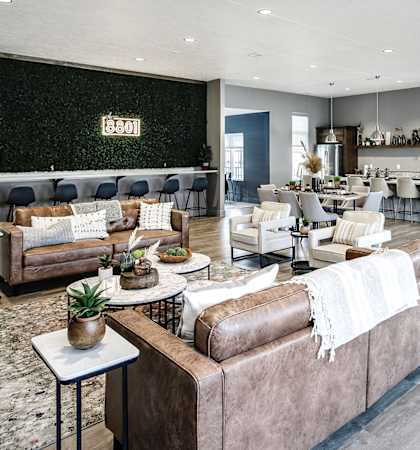 a large living room with couches and chairs and a bar