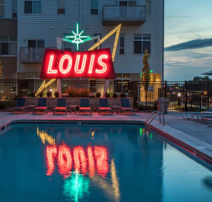A pool with the word Louis spelled out in the water.