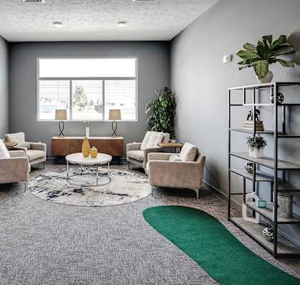 a living room with couches and chairs and a rug
