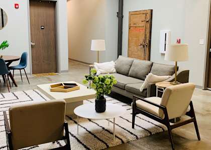 a living room filled with furniture and a rug