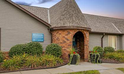 the front of a brick building with a arched doorway