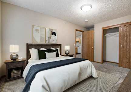 A bedroom with a large bed and a wooden headboard.