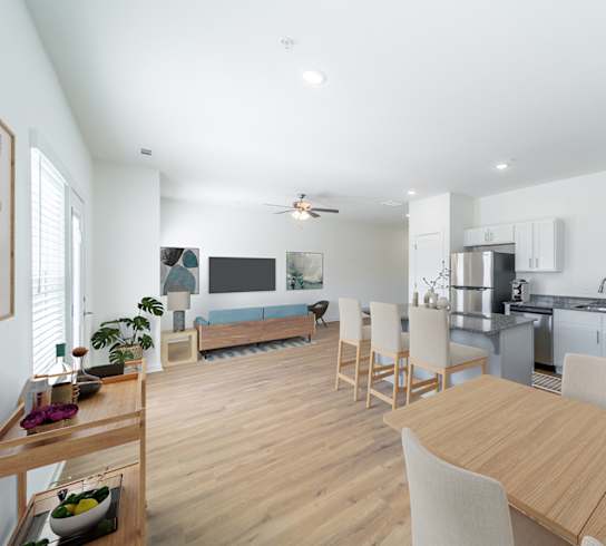 a living room with a dining room table and a kitchen