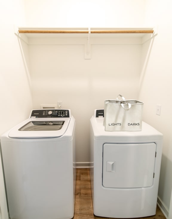 a small laundry room with a washing machine and a washer and dryer