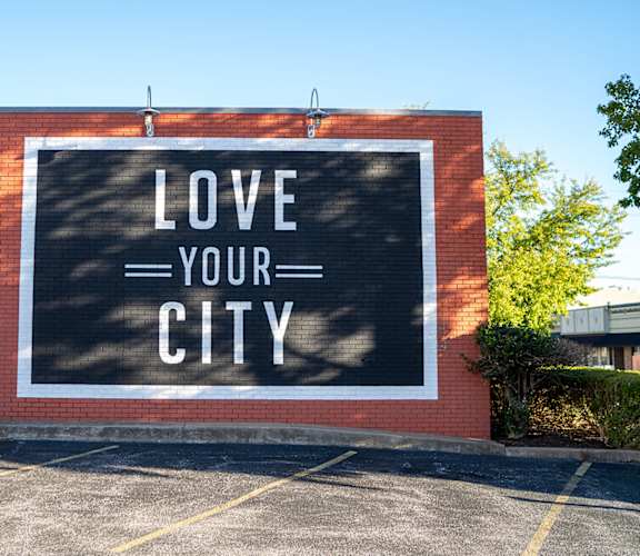 a mural on the side of a building that says love your city