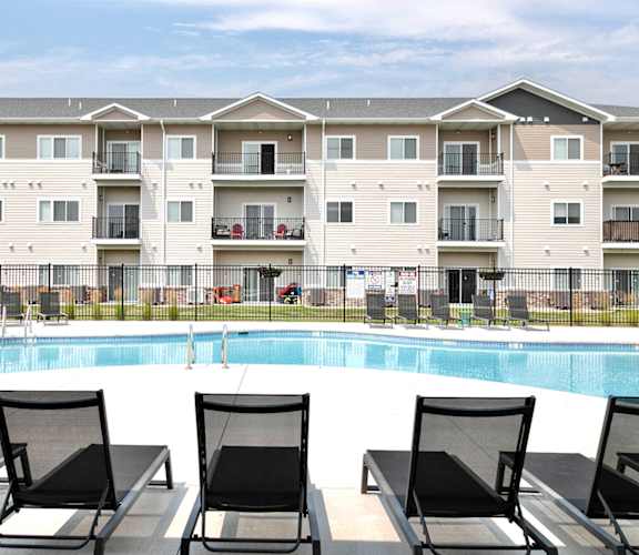a swimming pool in front of an apartment building